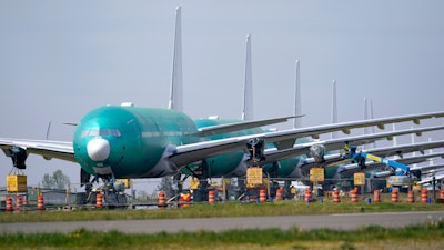 A line of Boeing 777X jets parked at Paine Field, Everett, Wash., April 23, 2021.