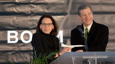 North Carolina Gov. Roy Cooper receives a model of Boom Supersonic's Overture jet from Boom President and Chief Business Officer Kathy Savitt, Greensboro, N.C., Jan. 26, 2022.