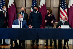 Stan Deal, President and CEO Boeing Commercial Airplanes, left, and Qatar Airways' CEO Akbar al-Baker, right, sign an agreement for the purchase of thirty-four 777-8 Freighter planes with purchase rights for an additional sixteen, in the Eisenhower Executive Office Building on the White House Campus in Washington, Monday, Jan. 31, 2022.