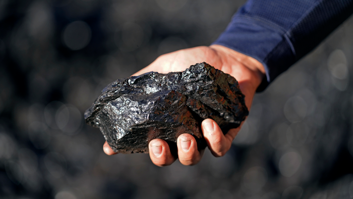 Sean Hovorka, production superintendent Trapper Mining, holds coal from the Trapper Mine on Thursday, Nov. 18, 2021, in Craig, Colo. Hovorka, also recently elected member of the town's city council, sees a future in mining because of renewables.