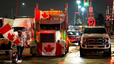 Truckers and supporters block the access leading from the Ambassador Bridge, linking Detroit and Windsor, as truckers and their supporters continue to protest against the COVID-19 vaccine mandates and restrictions in Windsor, Ontario on Feb. 9, 2022.