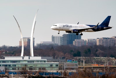 Passenger flights land and take off at Reagan Washington National Airport, Arlington, Va., Jan. 19, 2022.