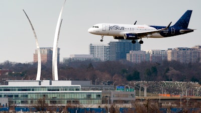 Passenger flights land and take off at Reagan Washington National Airport, Arlington, Va., Jan. 19, 2022.