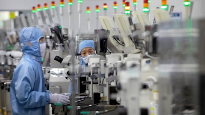 Employees at a Renesas Electronics semiconductor production facility, Beijing, May 14, 2020.