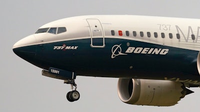 A Boeing 737 Max jet prepares to land at Boeing Field following a test flight in Seattle.