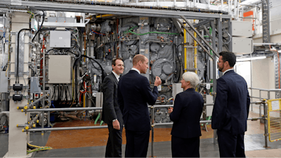 Britain's Prince William talks with, from left, Professor Ian Chapman, CEO of the UK Atomic Energy Authority, Nanna Heiberg, and Joseph Milnes, head of engineering design unit, alongside the MAST Upgrade chamber at the Culham Science Centre, Abingdon, England, Oct. 18, 2018.