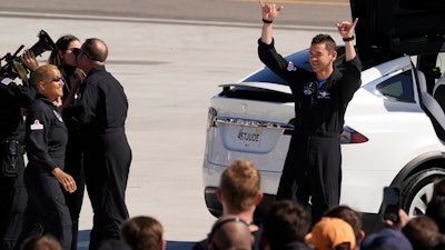 Inspiration4 crew member Jared Isaacman, right, waves to family members before a trip to Kennedy Space Center's Launch Pad 39-A, Sept. 15, 2021, Cape Canaveral, Fla.