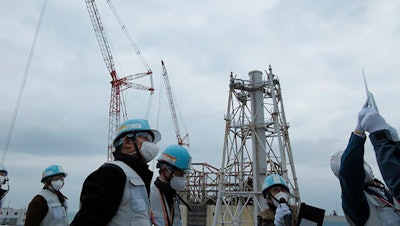 Members of the International Atomic Energy Agency inspect the site of Fukushima nuclear plant in Okuma town, Japan, Feb. 15, 2022.