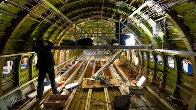 Engineers work on the conversion of a Boeing 767 passenger plane to a cargo plane at the Israel Aerospace Industries in Lod, Jan. 25, 2022.