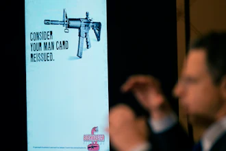 An ad for an AR-15-style rifle is displayed while attorney Josh Koskoff speaks during a news conference, Trumbull, Conn., Feb. 15, 2022.