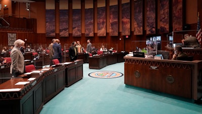 Members of the Arizona House gather at the Capitol in Phoenix, Feb. 18, 2021.