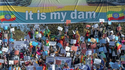 Ethiopians protest against international pressure on the government over the conflict in Tigray, below a banner referring to the Grand Ethiopian Renaissance Dam, Addis Ababa, May 30, 2021.