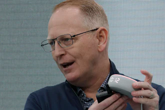 Dave Limp, senior vice president for Amazon devices & services, holds an Echo Dot with Clock device, Seattle, Sept. 25, 2019.