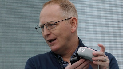 Dave Limp, senior vice president for Amazon devices & services, holds an Echo Dot with Clock device, Seattle, Sept. 25, 2019.
