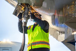 Aviation maintenance technician loads sustainable aviation fuel into the 2021 Boeing ecoDemonstrator.