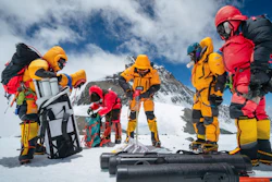 Mariusz Potocki and Sherpa team drilling the highest ice core ever recovered at 8020m elevation with the summit of Mount Everest in the background.