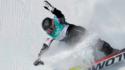 Climate change threatens the ideal environments for snowboarders, like U.S. Olympian Hailey Langland, competing here during the women’s snowboard big air final in Beijing.