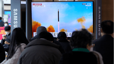 People watch a TV showing a file image of North Korea's missile launch during a news program at the Seoul Railway Station in Seoul, March 5, 2022.