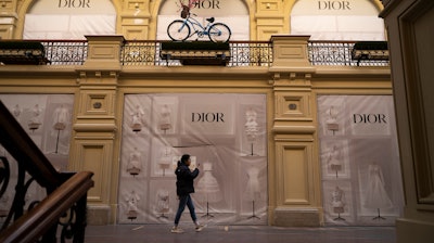 A visitor walks past a closed Dior boutique inside the GUM department store, Moscow, March 9, 2022.
