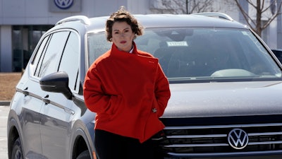 Kendall Heiman stands with a loner car in Lawrence, Kan., March 9, 2022.