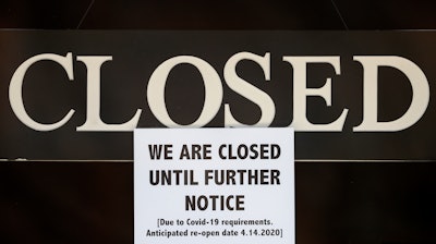 Closure notice posted at The Great Frame Up in Grosse Pointe Woods, Mich., April 2, 2020.