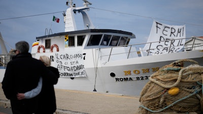 A fishing boat with banners protesting gasoline price increases, Fiumicino, Italy, March 11, 2022.