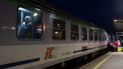 Ukrainian refugees embark a train bound to Warsaw at the Przemysl train station, southeastern Poland, March 11, 2022.