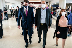 Sen. Bill Hagerty, R-Tenn., left, walks with Greg Kelly, center, and his wife, Dee Kelly, Nashville International Airport, March 14, 2022.