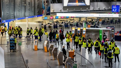 Security employees walk through an airport terminal during a one-day strike, Frankfurt, Germany, March 15, 2022.