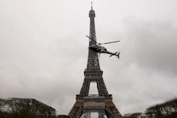 A helicopter installs a new telecom transmission TDF antenna on the top of the Eiffel Tower in Paris, March 15, 2022.