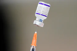 A syringe is prepared with the Pfizer COVID-19 vaccine at the Keystone First Wellness Center, Chester, Pa., Dec. 15, 2021.