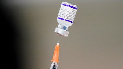 A syringe is prepared with the Pfizer COVID-19 vaccine at the Keystone First Wellness Center, Chester, Pa., Dec. 15, 2021.