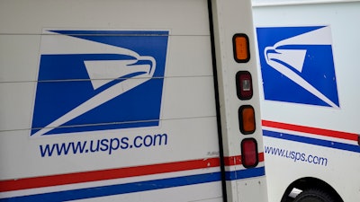 Mail delivery vehicles outside a post office in Boys Town, Neb., Aug. 18, 2020.