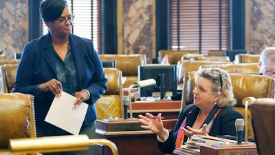 Mississippi state Sen. Angela Turner Ford, D-West Point, left, listens to Sen. Nicole Boyd, R-Oxford, at the Capitol in Jackson, March 28, 2022.