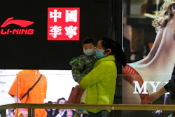 Visitors to a mall walk past signs of Chinese sports brand Li Ning on Wednesday, March 16, 2022, in Beijing. The U.S. customs agency says it is holding imported goods from Li Ning after an investigation indicated they were made by North Korean labor. U.S. law prohibits imports of goods made in North Korea or by North Korean citizens without proof they weren’t made by forced labor, according to a notice from the U.S. Customs and Border Protection in Washington.