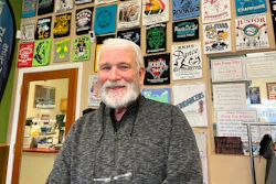 Wayne Holly, the owner of Rio Rancho T-Shirts, poses for a portrait at the family-owned shop in Rio Rancho, N.M., Monday, March 21, 2022. Holly said the small business he and his wife have operated for more than 20 years is feeling the pinch of inflation and that tax rebates offered by state governments won't be enough to combat rising prices or ongoing economic fallout from the coronavirus pandemic.