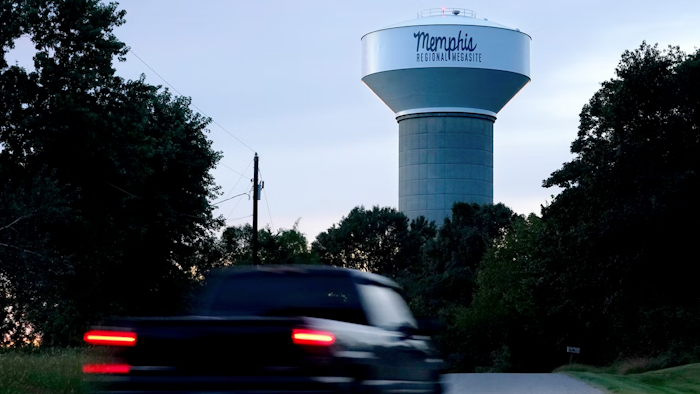 A truck drives down a rural road near a water tower marking the location of the Memphis Regional Megasite, Sept. 24, 2021, Stanton, Tenn.