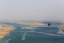 An army zodiac secures the entrance of a new section of the Suez Canal in Ismailia, Egypt, Aug. 6, 2015. Cash-strapped Egypt increased transit fees Tuesday, March 1, 2022, for ships passing through the Suez Canal, one of the world’s most crucial waterways, with hikes of up to 10%, officials said.