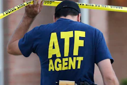 An ATF agent lifts crime scene tape, DeSoto, Texas, Aug. 8, 2013.