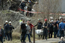 Rescue workers carry a body after a shaft collapsed in Soko coal mine, Serbia, April 1, 2022.