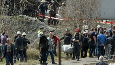 Rescue workers carry a body after a shaft collapsed in Soko coal mine, Serbia, April 1, 2022.