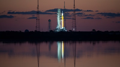 In this photo released by NASA, the Space Launch System (SLS) rocket with the Orion spacecraft aboard is seen at sunrise atop a mobile launcher at Launch Complex 39B at NASA's Kennedy Space Center in Cape Canaveral, Fla., Monday, April 4, 2022, in preparation for the Artemis I wet dress rehearsal test. Launch managers tried twice _ once Sunday and again Monday _ to load nearly 1 million gallons of fuel into the 322-foot (98-meter) rocket. Problems with fans at the launch pad thwarted the first effort, while a stuck valve halted the second attempt.