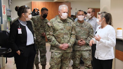 n this image provided by the U.S. Army, University of Utah Health staff speak with the U.S. Army North personnel in Salt Lake City, Utah, March 2, 2022, during a visit to the University of Utah Hospital.