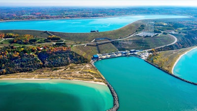 This undated photo provided by Consumers Energy shows an aerial view of the Ludington Pumped Storage Plant near Ludington, Mich. The plant generates electricity by pumping water from Lake Michigan to a reservoir on top of a bluff, then releasing it through giant turbines as needed. Advocates of pumped storage call such facilities the 'world's largest batteries.'