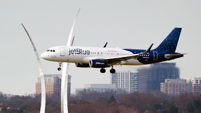 A JetBlue passenger flight passes the Air Force Memorial as it prepares to land at Reagan Washington National Airport in Arlington, Va., across the Potomac River from Washington, Wednesday, Jan. 19, 2022. Air travel is expected to make close to a full recovery in 2022, and for airlines looking to take advantage of the rebound, size matters. Fleet size is a key motive for JetBlue’s bid to woo budget carrier Spirit Airlines and break up that company’s deal with rival Frontier.