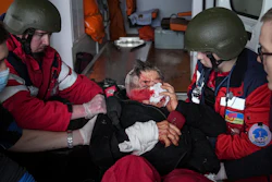 Ambulance paramedics move a civilian wounded in shelling onto a stretcher to a maternity hospital converted into a medical ward in Mariupol, Ukraine, March 2, 2022. A bipartisan group of U.S. lawmakers is calling on the Biden administration to establish field hospitals near Ukraine's border and ramp up medical support for what's expected to be a months-long war of attrition waged by Russia.