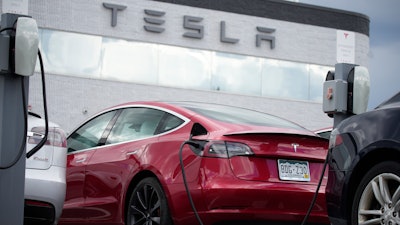 A 2021 Tesla Model 3 sedan sits in a near-empty lot at a Tesla dealership in Littleton, Colo. June 27, 2021. Tesla has recalled 14,684 Model 3s due to a software glitch that could cause collisions, its second recall this month, China's market regulator said Friday, April 29, 2022.