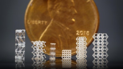 Researchers at UC Berkeley have developed a new way to 3D-print glass microstructures, including these 3D printed glass lattices, which are displayed in front of a U.S. penny for scale.