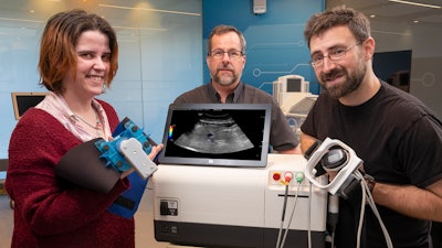 Pictured (left to right): GE Research’s Victoria Cotero, Senior Scientist in Biosciences; Jeffrey Ashe, a senior electrical engineer; and Christopher Puleo, a senior biomedical engineer, around a prototype of the Research Lab’s ultrasound modulation device at GE’s research campus in Niskayuna, NY. Cotero, Ashe and Puleo were lead authors on the GE Research- led study with The Feinstein Institutes for Medical Research, UCLA Samueli School of Engineering, Yale School of Medicine, and Albany Medical College, published in Nature Biomedical Engineering.