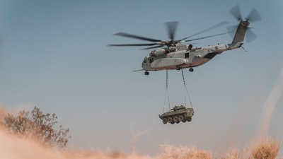 In this Aug. 21, 2021 photo, a CH-53K King Stallion with Marine Operational Test and Evaluation Squadron 1 conducts a lift of an external cargo load during a cargo loading and transporting exercise at Marine Corps Air Ground Combat Center, Twentynine Palms, California.